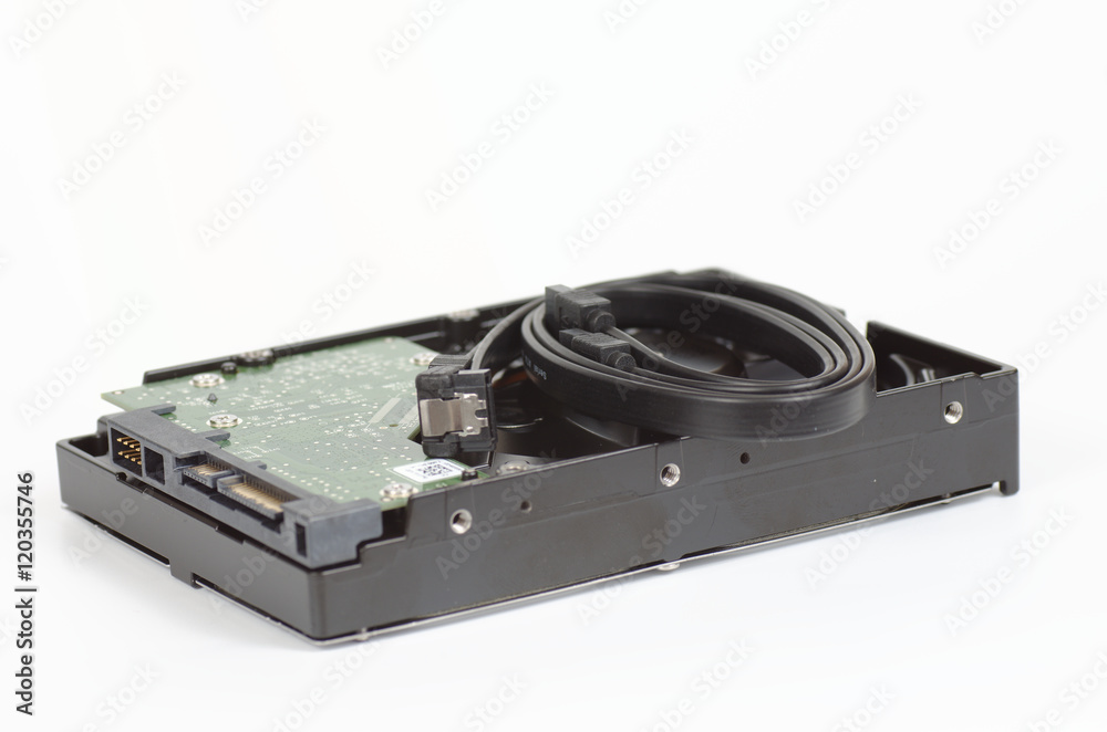 HDD with SATA cable on white background closeup. Selective focus. HDD with SATA cable on white background closeup. Selective focus.