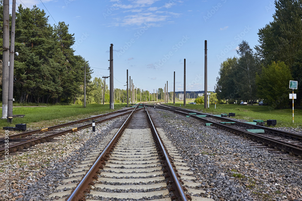 Obraz premium Railway or railroad tracks for train transportation under blue sky
