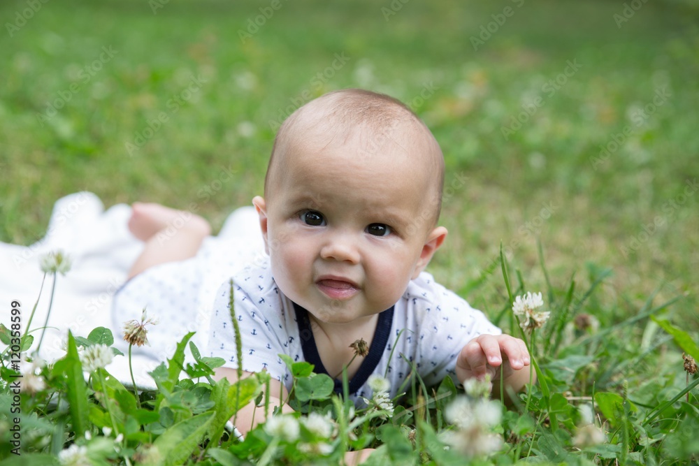 Baby girl crawling on the grass. Selective focus her eyes. Baby girl crawling on the grass. Selective focus her eyes.