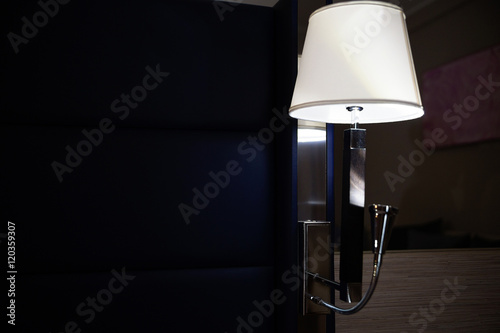 Lamp night light in a dark background in hotel room.