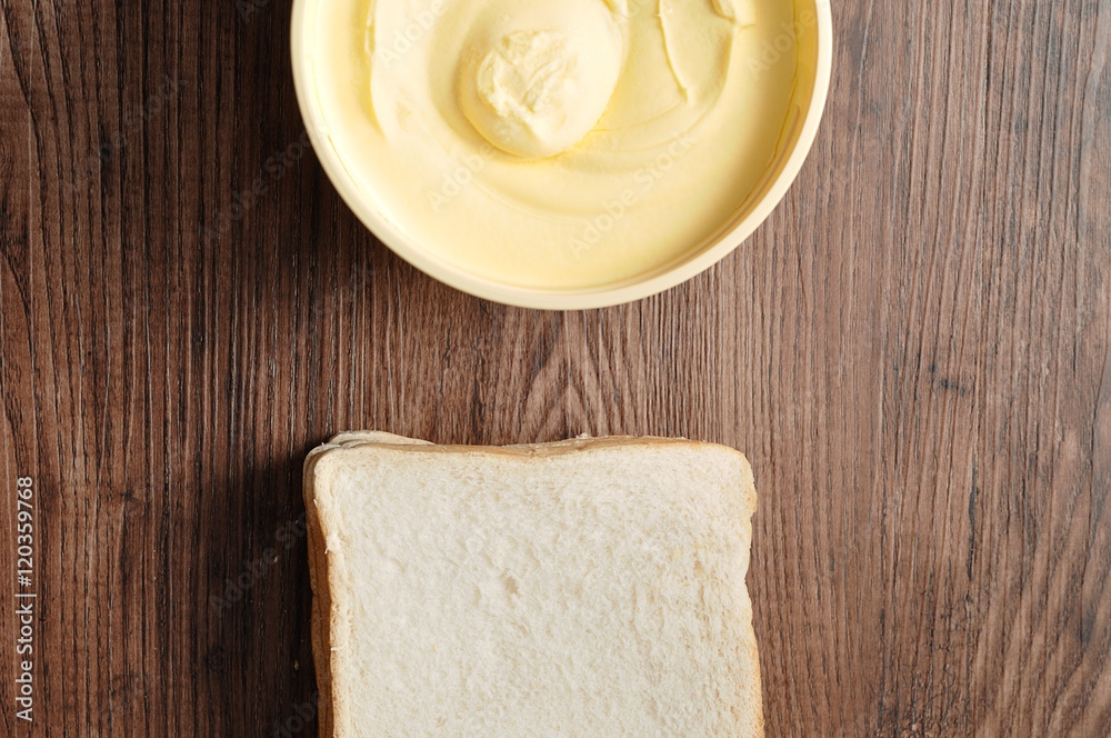 Butter and bread isolated on a wooden background Butter and bread isolated on a wooden background