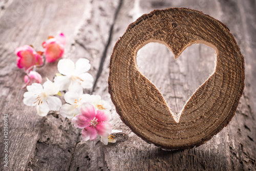 Light heart on rustic wooden background