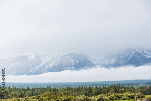 Grand Teton mountains covered with fog and clouds