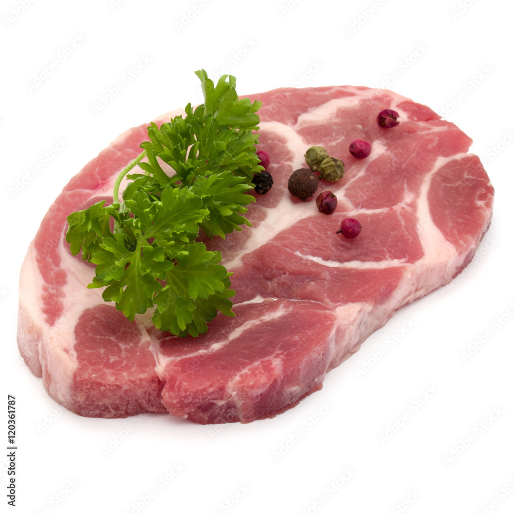 Raw pork neck chop meat with parsley herb leaves and peppercorn