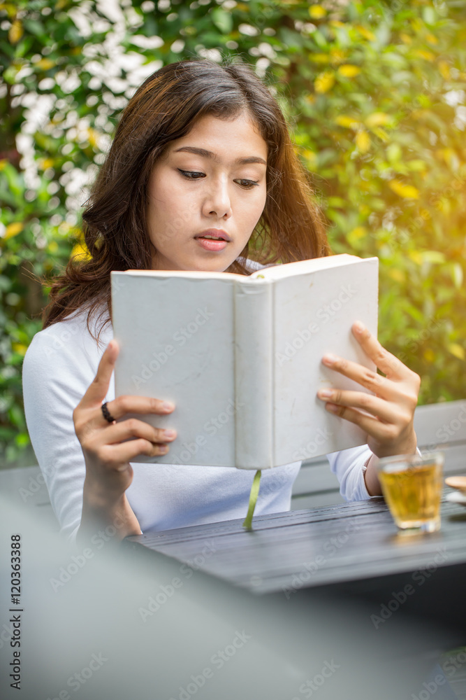 Asian women reading book in the garden