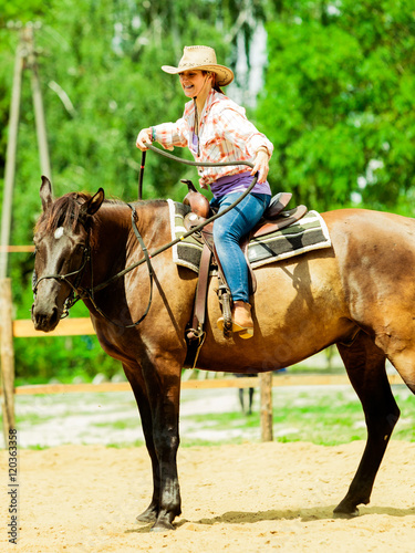 Western cowgirl woman riding horse. Sport activity © Voyagerix