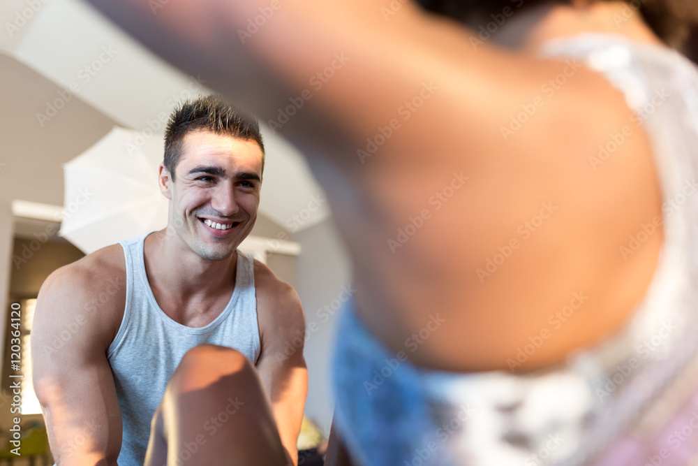 Beautiful young woman working out at the gym with the help of he Beautiful young woman working out at the gym with the help of he