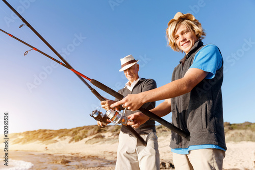 Senior man fishing with his grandson