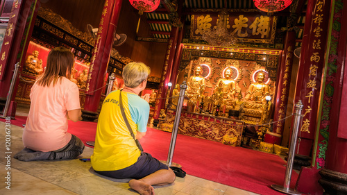 Photography People worship on Three Buddha gold statue chinese style in Wat Leng Nei Yee Chinese temple in Yaowarat road,Bangkok capital city,Thailand