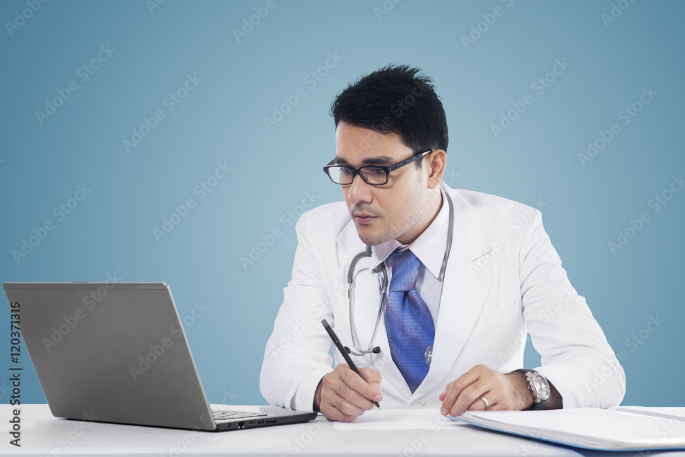 Physician makes prescription with notebook Physician makes prescription with notebook