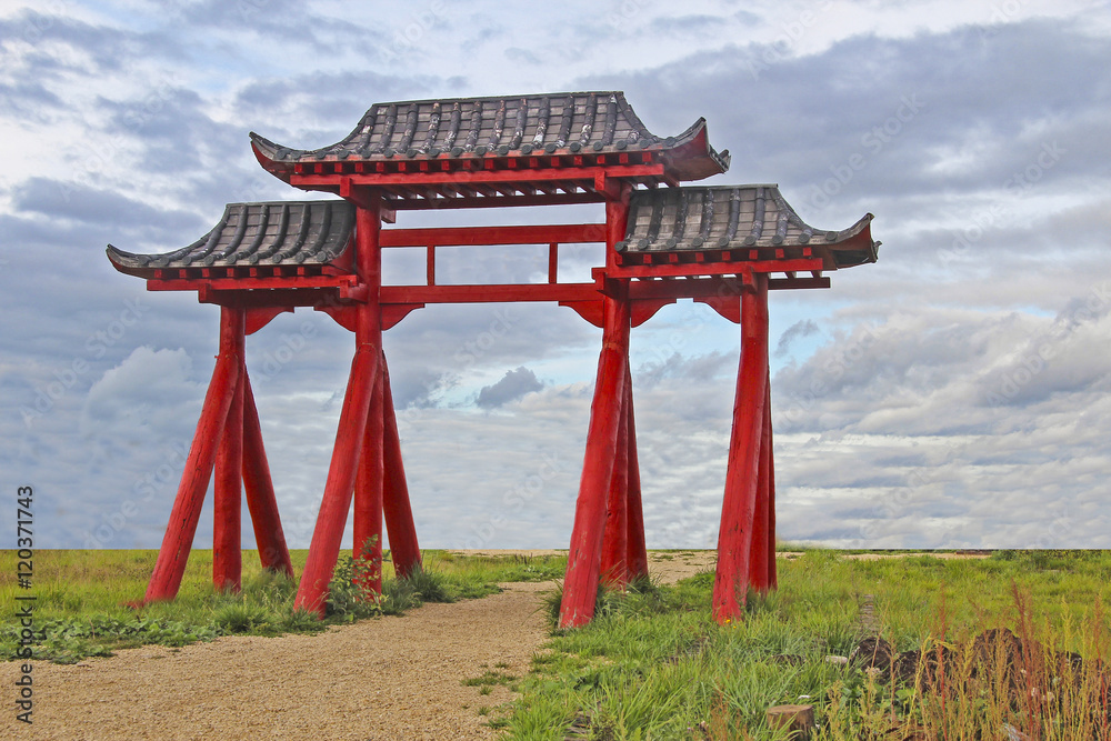 Chinese red wooden pagoda on the road against the sky Chinese red wooden pagoda on the road against the sky