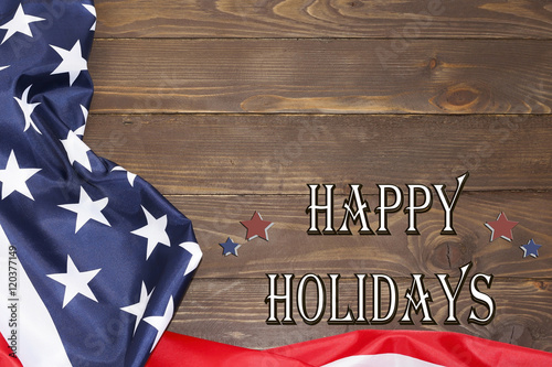 Happy holiday. American flag, text on a wooden background. The view from the top, a place for advertising.