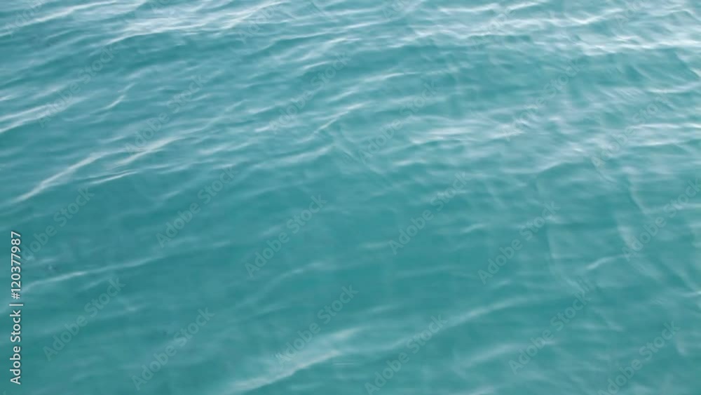 Sun glinting off gentle waves rippling across water Sun glinting off gentle waves rippling across water
