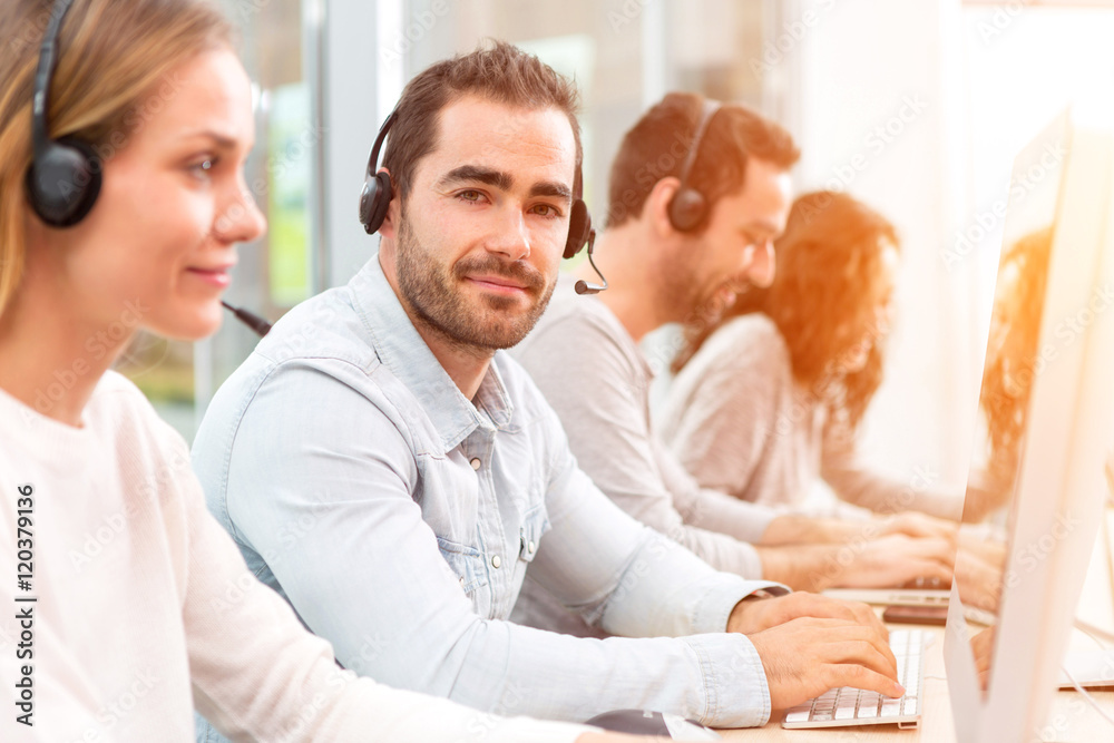 Young attractive man working in a call center Young attractive man working in a call center