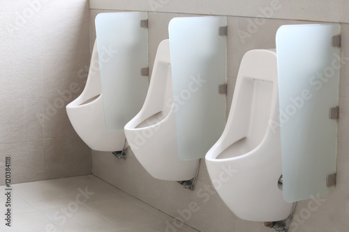 Modern urinal in men bathroom.