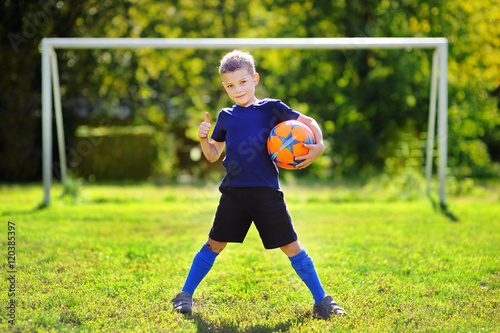 Little boy having fun playing a soccer game © Maria Sbytova