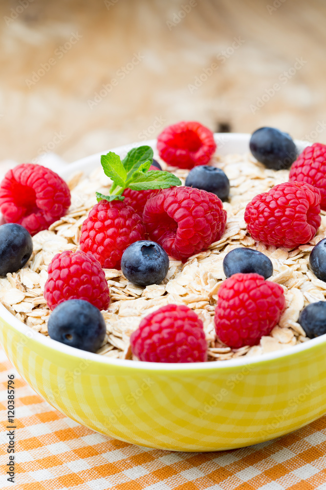 Oatmeal porridge with berries. Raspberries and blueberries. Oatmeal porridge with berries. Raspberries and blueberries.