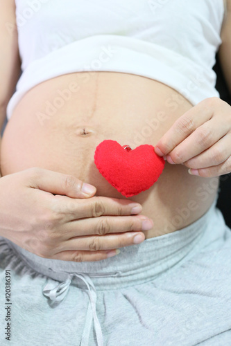 Wallpaper Mural Red heart symbol in hand a asian women pregnant. Torontodigital.ca