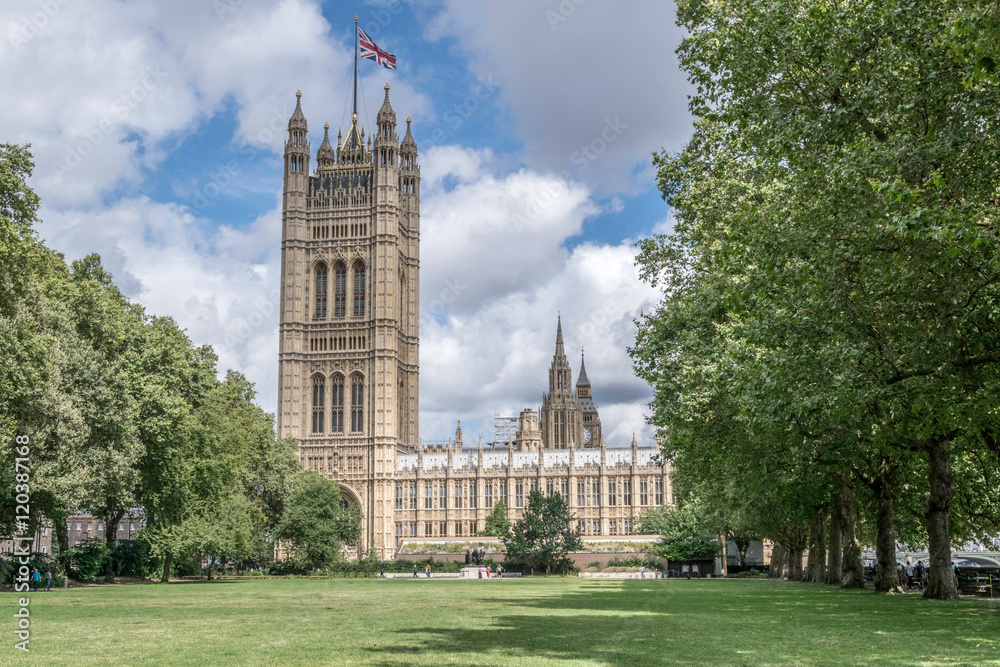 Obraz premium Westminster Palace, London, UK. View from the Victoria Tower Gardens with blue sky and clouds