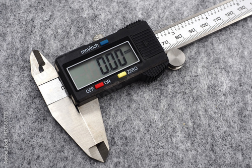 digital vernier caliper (measurement tool) on grey background. photo