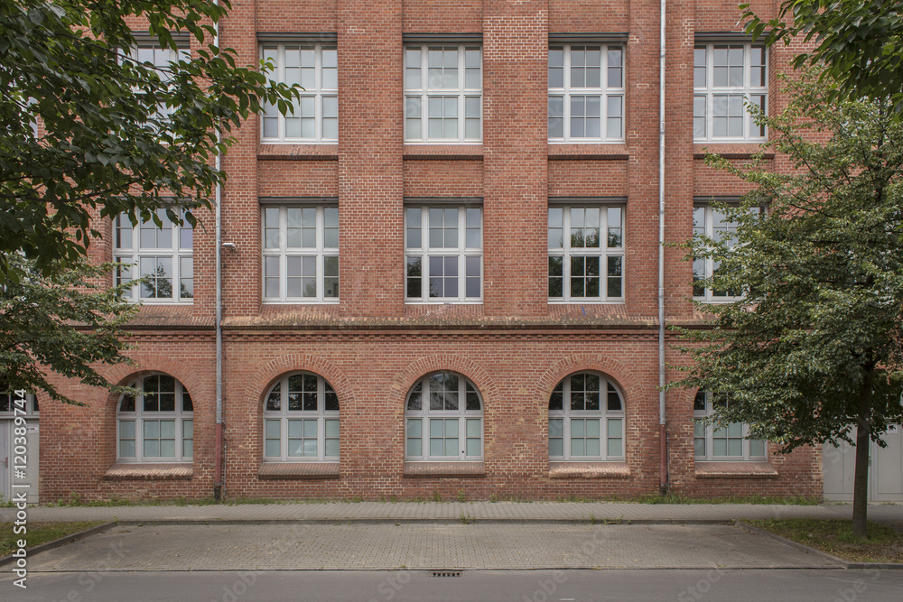 red brick building facade and sidewalk