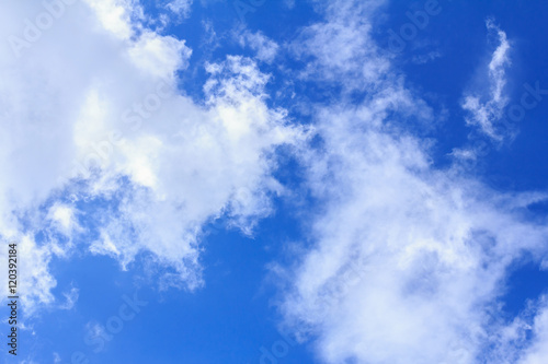 Blue sky background with white clouds. The vast blue sky and clouds sky on sunny day. White fluffy clouds in the blue sky.