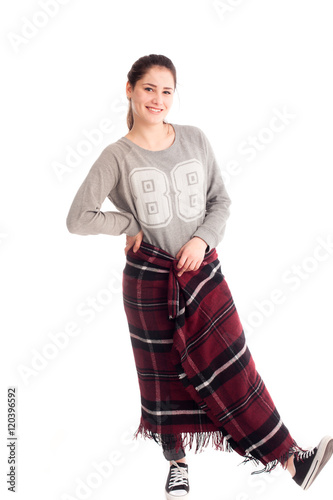Pretty young girl posing in studio with blanket isolated
