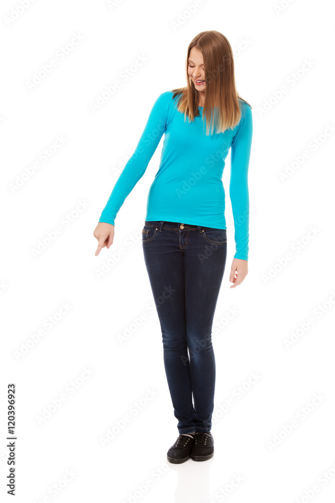 Young woman pointing down
