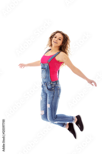 Young happy blonde woman jumping 