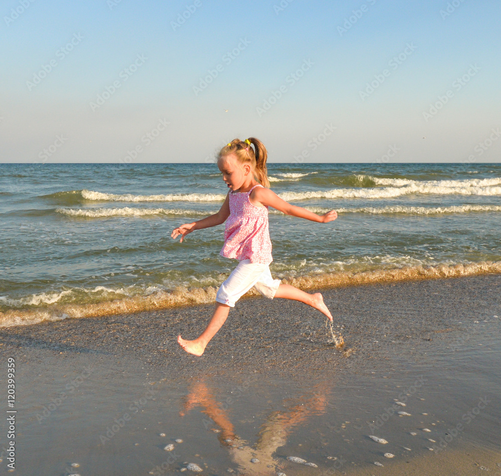 Little sweet girl runs along the beach and have fun/Little sweet girl runs along the beach and have fun. Black sea, Ukraine/Little sweet girl runs along the beach and have fun. Little sweet girl runs along the beach and have fun/Little sweet girl runs along the beach and have fun. Black sea, Ukraine/Little sweet girl runs along the beach and have fun.