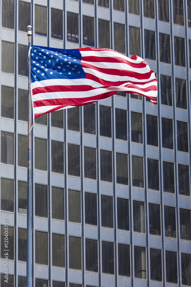 US american symbol flag over blue modern city buildings