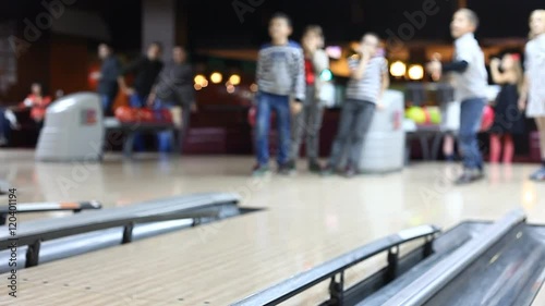 people play bowling, blurred background