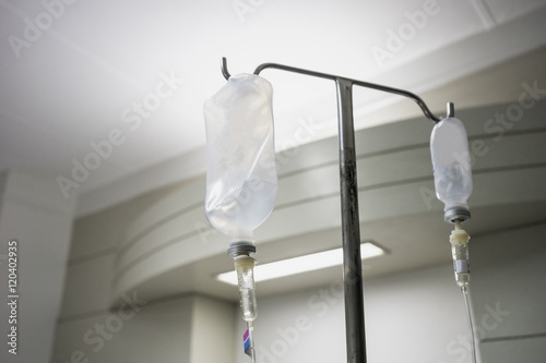 IV intravenous bag tube drip hang on silver metal stick therapy treatment to cue in hospital or clinic for patient