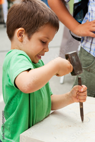  Child sculptor with chisel