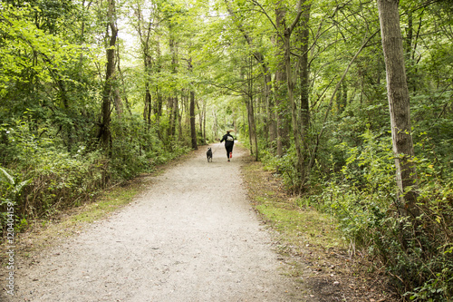 Women running with dog in the woods
