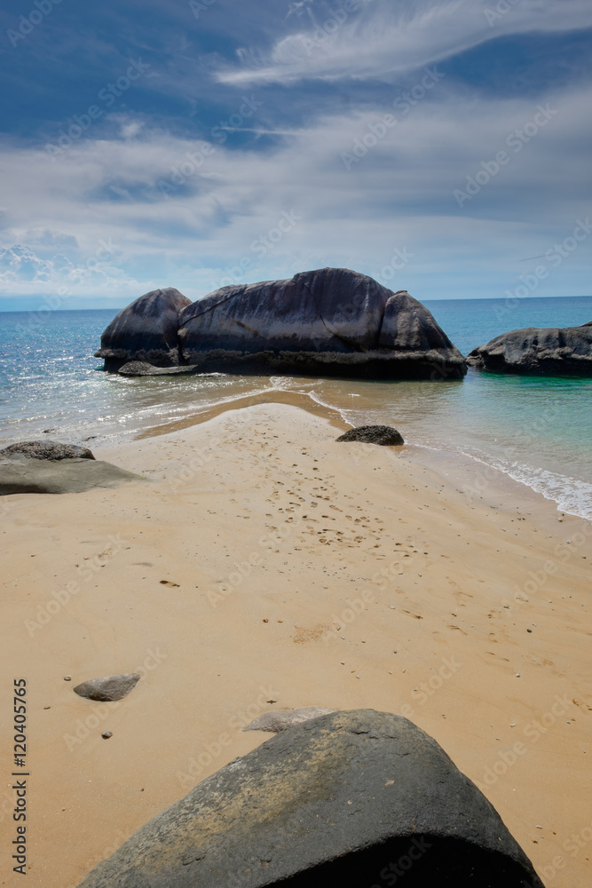 Tropical island sea shore with sand and rocks. Beautiful sunny d