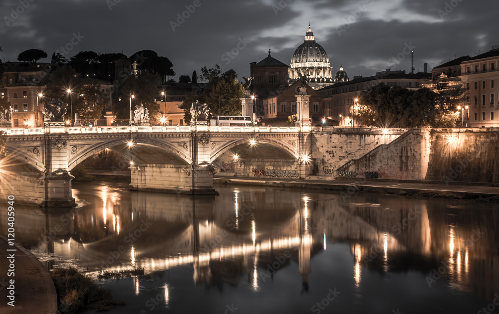 Rome and Vatican, cityscape at night, with St peter's basilica and bridge over the river Tiber