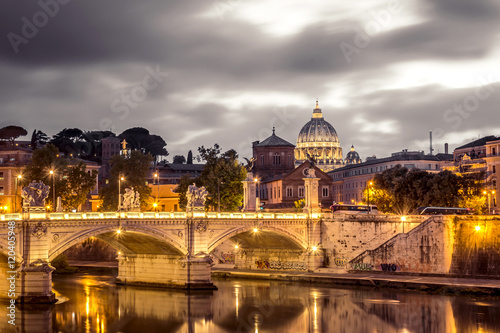 Rome and Vatican, cityscape at night, with St peter's basilica and bridge over the river Tiber