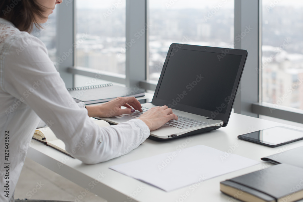 Working with laptop woman writing a blog. Female hands on the keyboard.