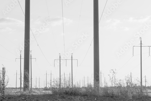 High-voltage power transmission towers in sunset sky background