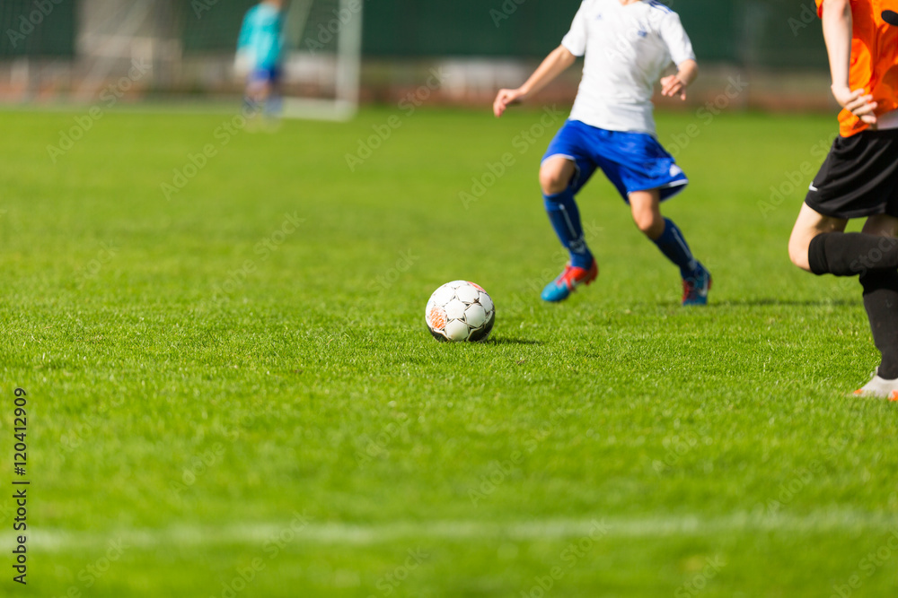 Blurred soccer players on green pitch