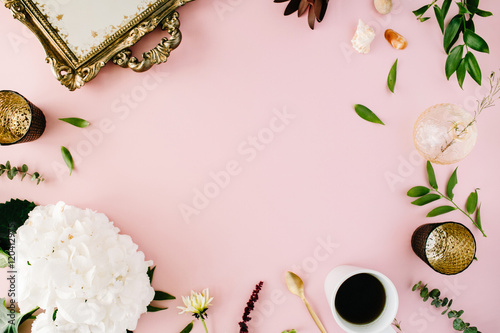 creative decorated and arranged flat lay frame concept with vintage tray, hydrangea, shells, coffee, golden spoon, branches on pink background. top view