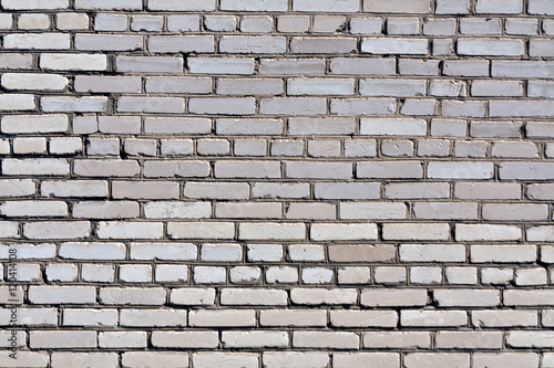 Weathered grey brick wall texture.