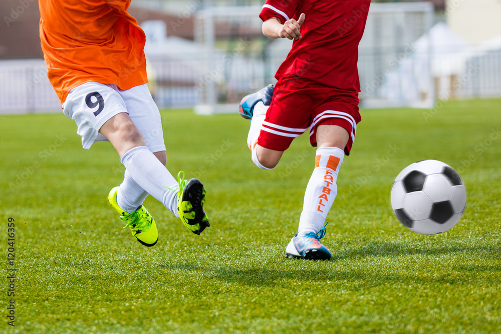 Children kicking football soccer match. Football match for young boys. Training and football soccer tournament Children kicking football soccer match. Football match for young boys. Training and football soccer tournament
