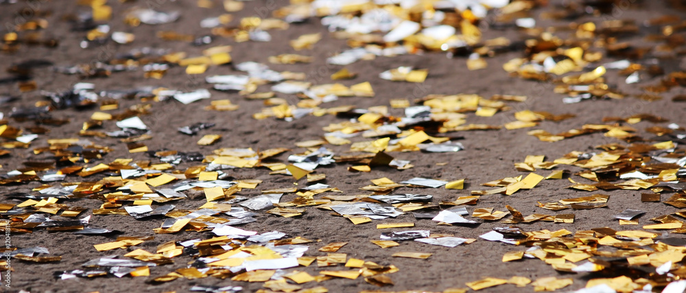 festival background with gold and silver sequins that lie on the pavement the road bokeh. festival background with gold and silver sequins that lie on the pavement the road bokeh.