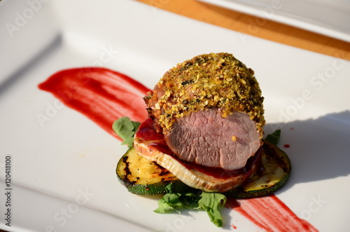 Roasted pork tenderloin with walnut and peppercorn crust. photo