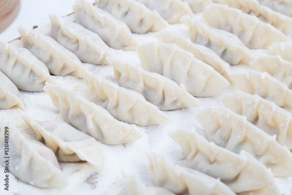 raw dumplings on the wooden desk raw dumplings on the wooden desk