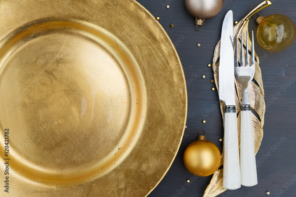 Christmas empty golden plate with knife and fork