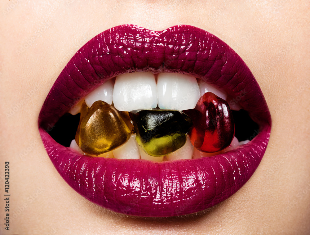 Obraz premium Beautiful female lips with multicolored gummi bears