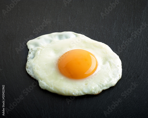 fried egg on black background